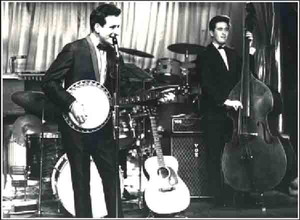 Lonnie Donegan on stage, early AC50 behind him